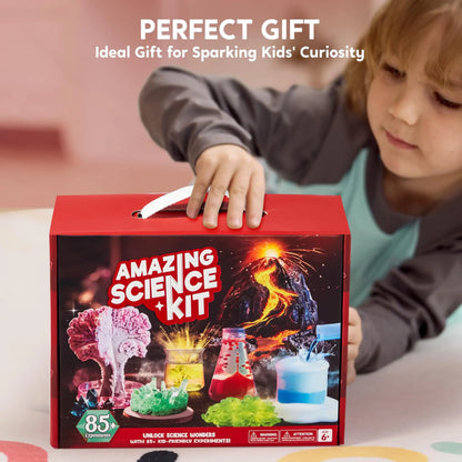 Child holding Amazing Science Kit gift box with volcano and colorful experiments on table