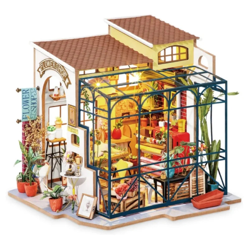 Miniature flower shop model with glass greenhouse, potted plants, and detailed interior décor