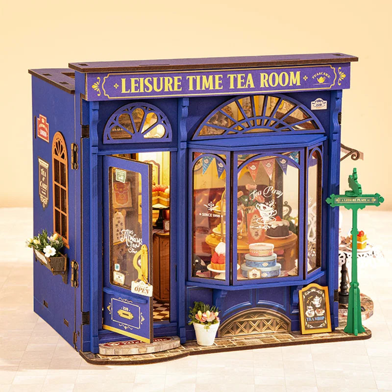 Miniature blue tea shop model with 'Leisure Time Tea Room' sign and bakery display window
