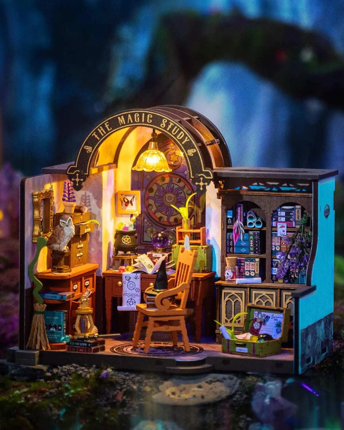 Miniature magic study room diorama with wooden furniture, books, owl, and mystical decor