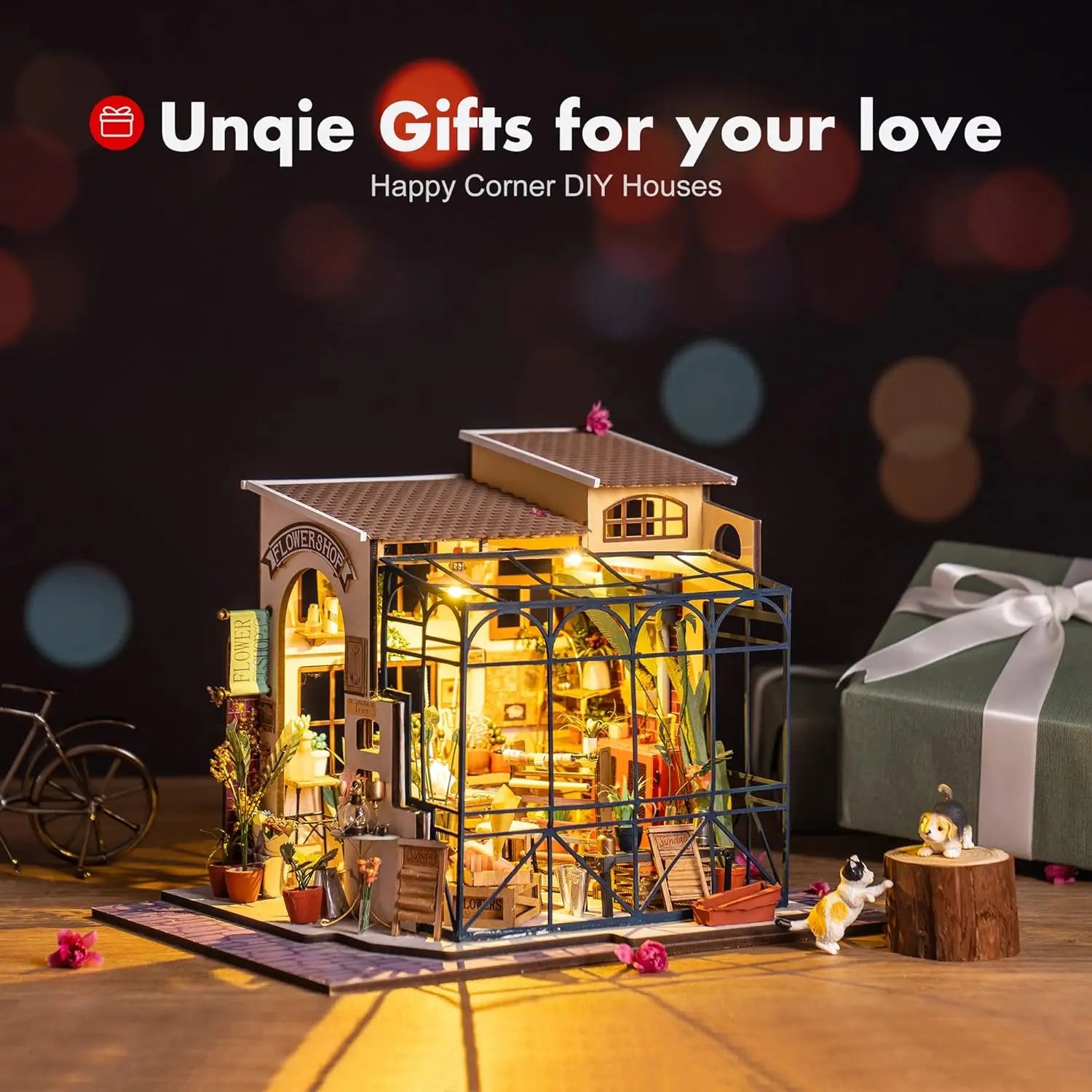 Miniature flower shop DIY house kit with lights, gift box, and decorative cats on wooden table