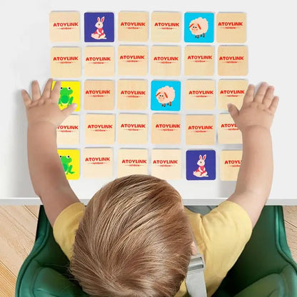 Toddler playing ATOYLINK animal matching game with wooden cards on table