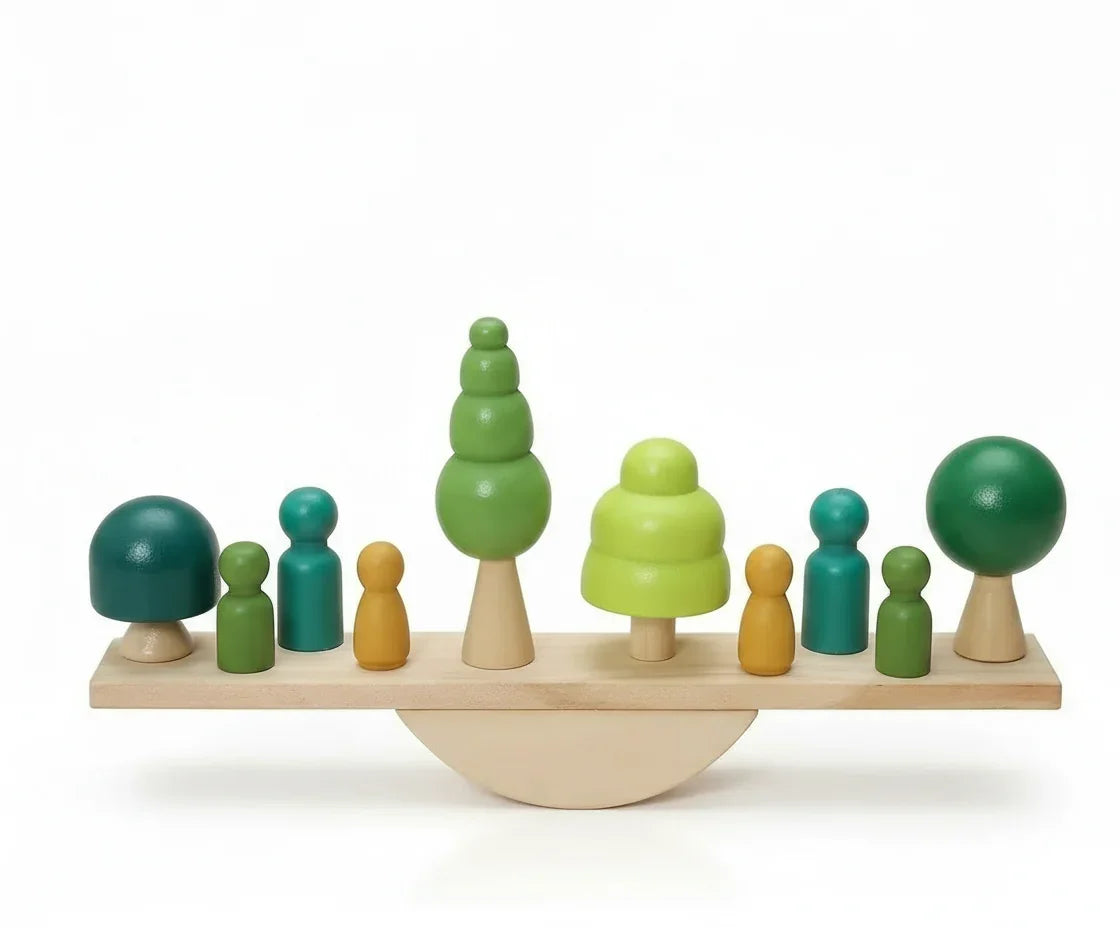Wooden balancing toy with green trees and peg people on a seesaw base